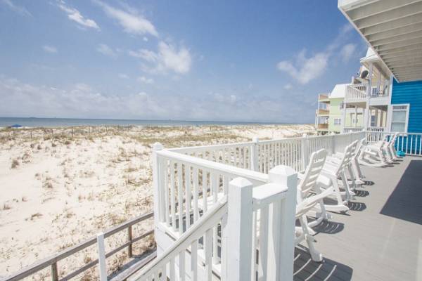 White lounge chairs on beachfront deck
